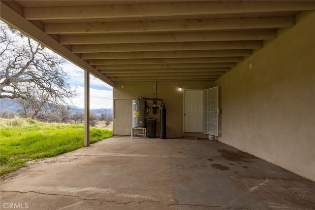 view of patio with water heater and a mountain view