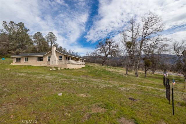 view of yard with a wooden deck and fence