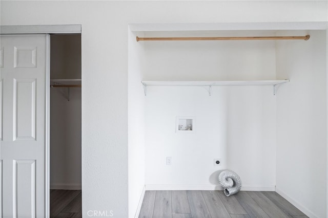 laundry area with laundry area, washer hookup, electric dryer hookup, and wood finished floors