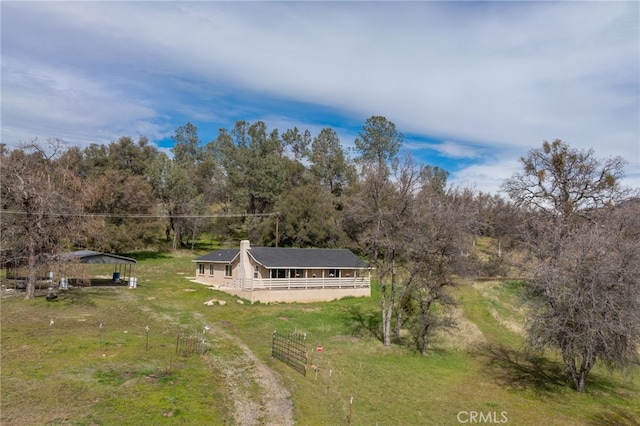 drone / aerial view featuring a wooded view