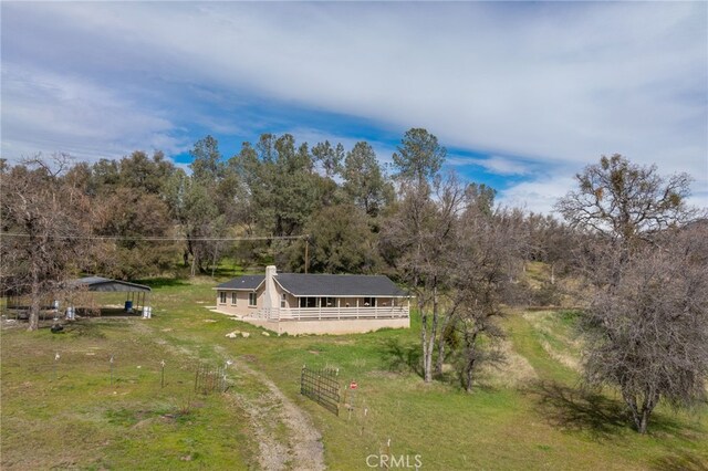 birds eye view of property with a forest view