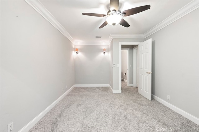 spare room featuring baseboards, visible vents, carpet flooring, and ornamental molding