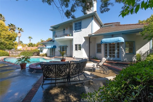 back of property featuring a patio, french doors, fence, and a balcony