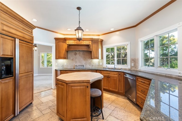 kitchen with stainless steel dishwasher, a sink, stone tile floors, and a kitchen island