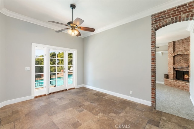 spare room with baseboards, stone finish flooring, and crown molding