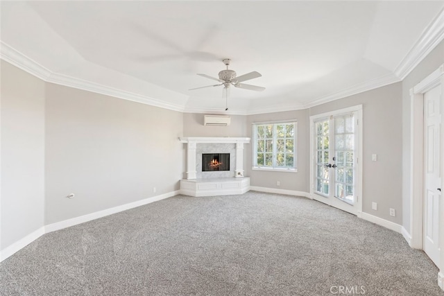 unfurnished living room featuring a wall unit AC, baseboards, a premium fireplace, and carpet floors