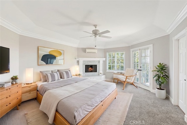 bedroom featuring light carpet, an AC wall unit, ornamental molding, and a fireplace