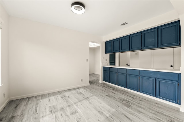 interior space with visible vents, baseboards, and light wood finished floors