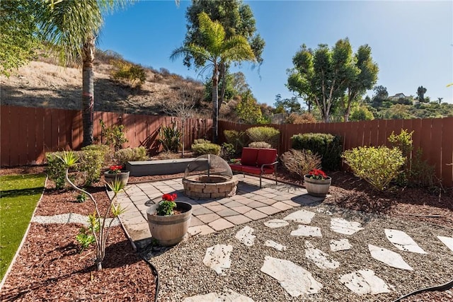 view of patio featuring an outdoor fire pit and a fenced backyard