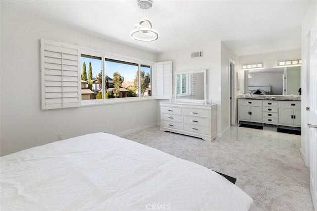 bedroom with visible vents, connected bathroom, and baseboards