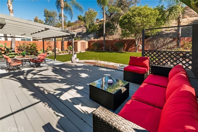 deck featuring a fenced backyard, an outdoor hangout area, a pergola, and a yard