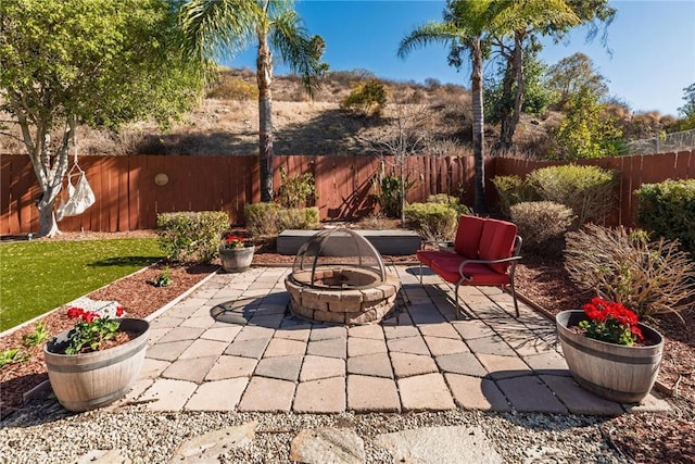 view of patio / terrace with a fire pit and a fenced backyard