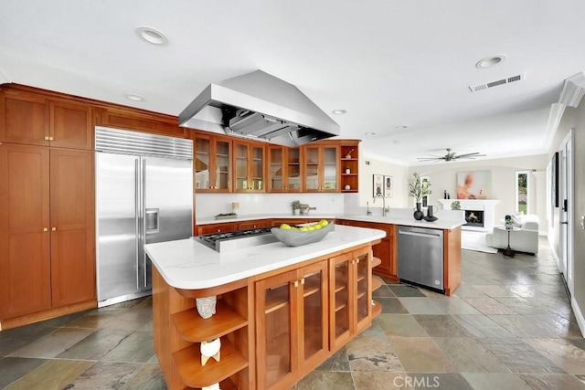 kitchen with open shelves, appliances with stainless steel finishes, a peninsula, and wall chimney range hood