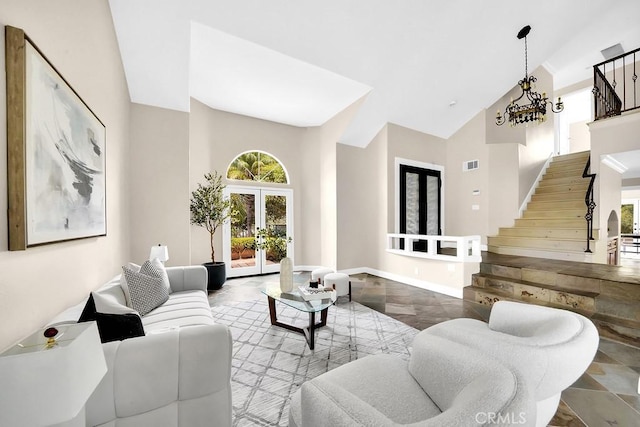 living room featuring french doors, a chandelier, visible vents, high vaulted ceiling, and stairs