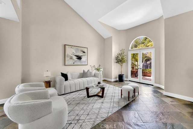 living room with high vaulted ceiling, french doors, and baseboards