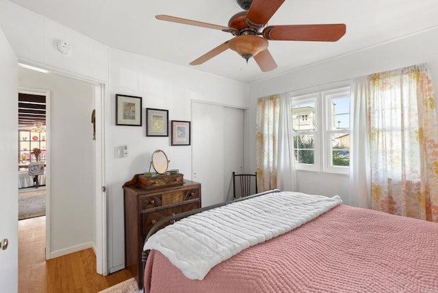 bedroom featuring light wood-type flooring, a closet, and ceiling fan