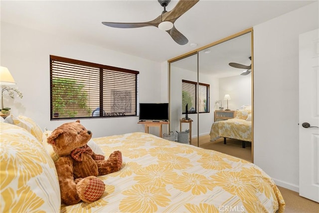 bedroom featuring a closet, carpet flooring, a ceiling fan, and baseboards