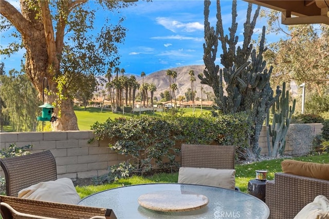 balcony featuring outdoor dining area and a mountain view