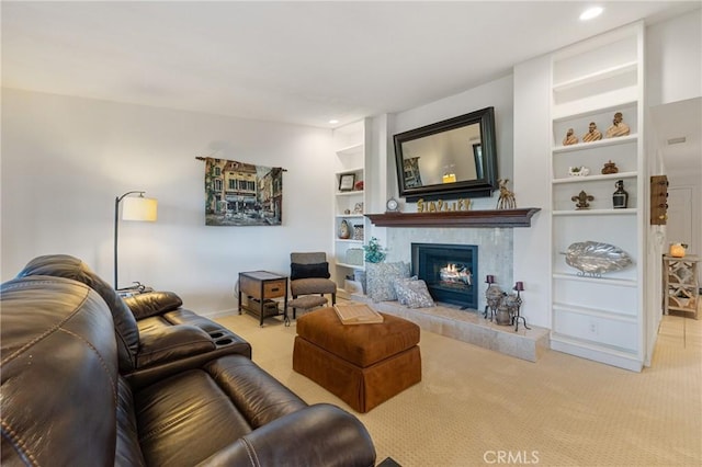 living area with carpet floors, a fireplace, built in features, and recessed lighting