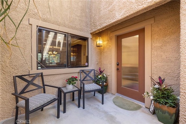 doorway to property featuring stucco siding