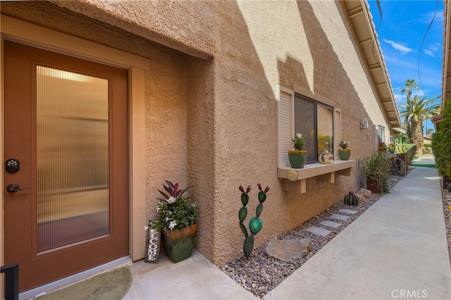 doorway to property with stucco siding