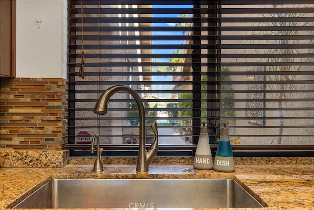 interior details featuring stone counters and a sink