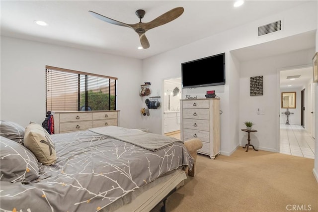 bedroom with recessed lighting, visible vents, light carpet, connected bathroom, and baseboards