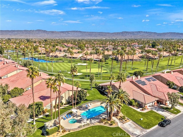 drone / aerial view featuring a residential view, a mountain view, and golf course view