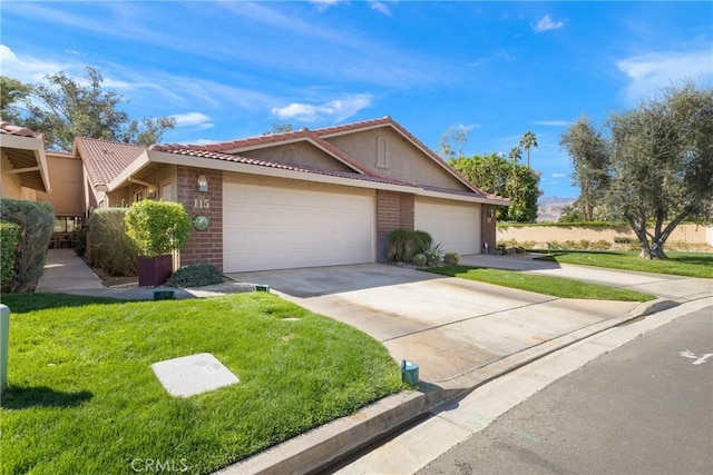 single story home featuring brick siding, concrete driveway, a tiled roof, an attached garage, and a front yard