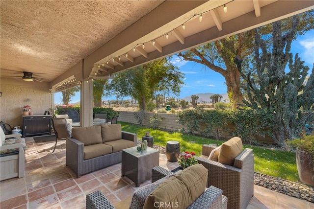 view of patio with a fenced backyard, ceiling fan, and outdoor lounge area