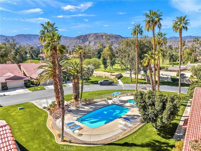 view of swimming pool with a mountain view