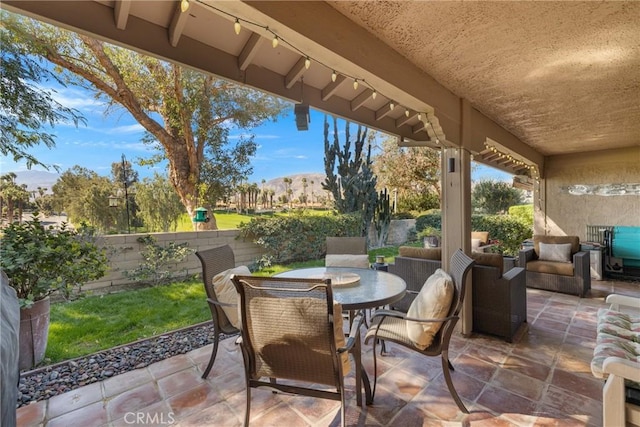 view of patio / terrace featuring outdoor dining area and fence