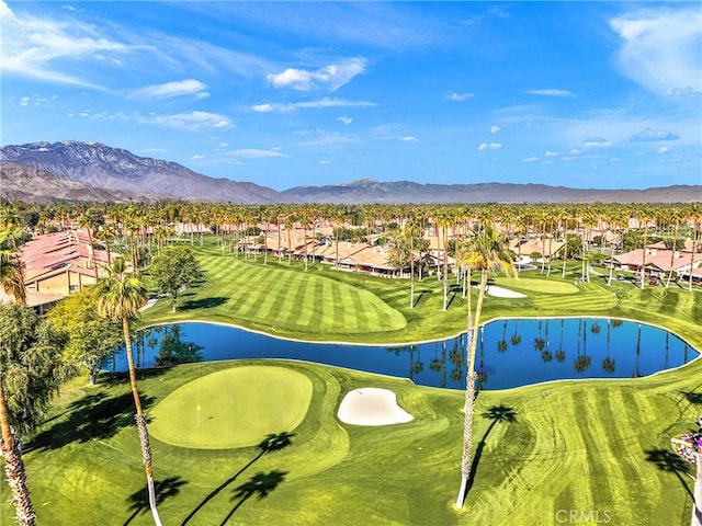 aerial view featuring golf course view and a water and mountain view