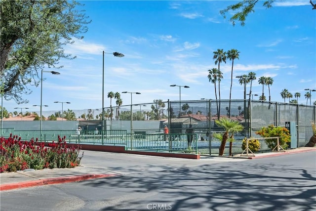 view of tennis court with fence