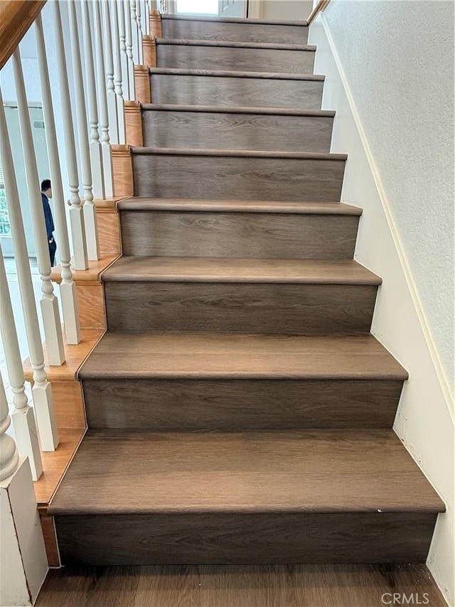 stairway with wood finished floors