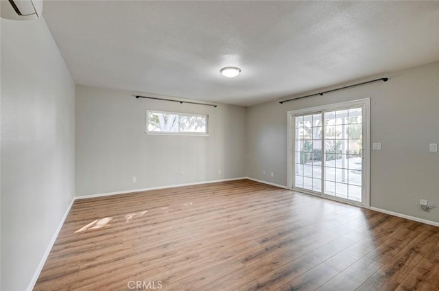 unfurnished room featuring baseboards and wood finished floors