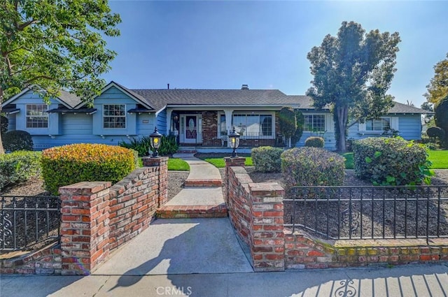 ranch-style house featuring fence and brick siding