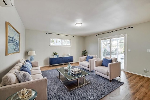 living room featuring baseboards and wood finished floors