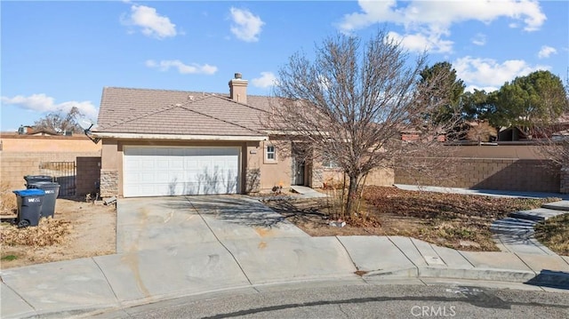 single story home featuring driveway, fence, an attached garage, a chimney, and a tiled roof