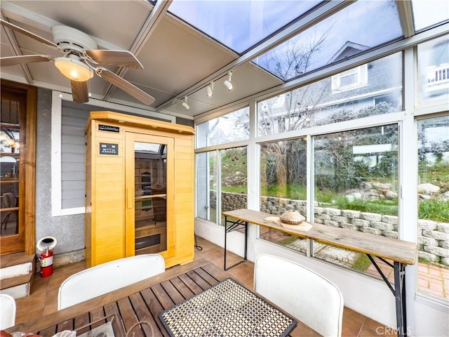 sunroom / solarium featuring ceiling fan