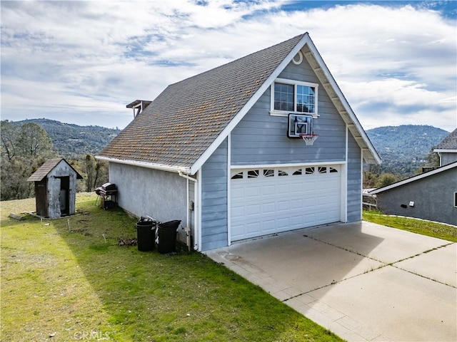 detached garage featuring a mountain view