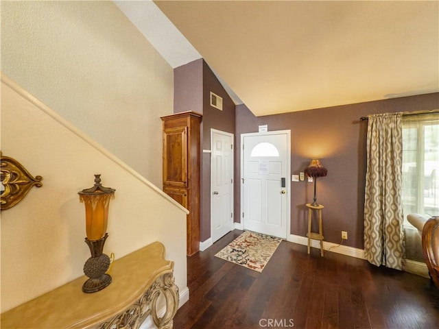 entryway featuring vaulted ceiling, wood-type flooring, visible vents, and baseboards