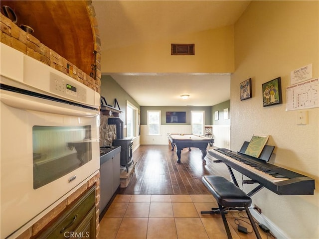 kitchen featuring tile patterned floors, billiards, visible vents, and white oven