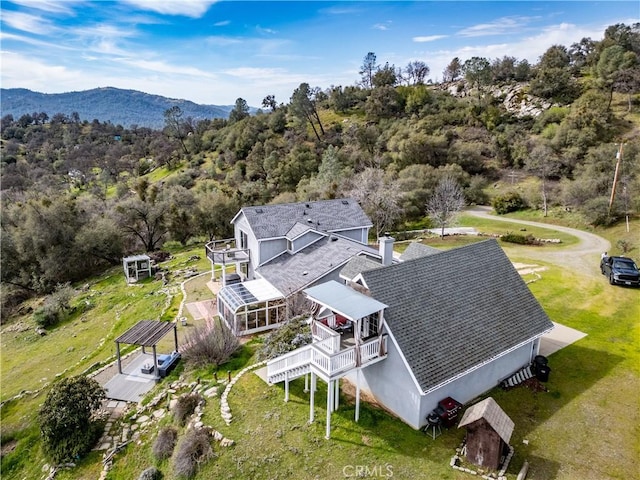 bird's eye view with a mountain view and a view of trees