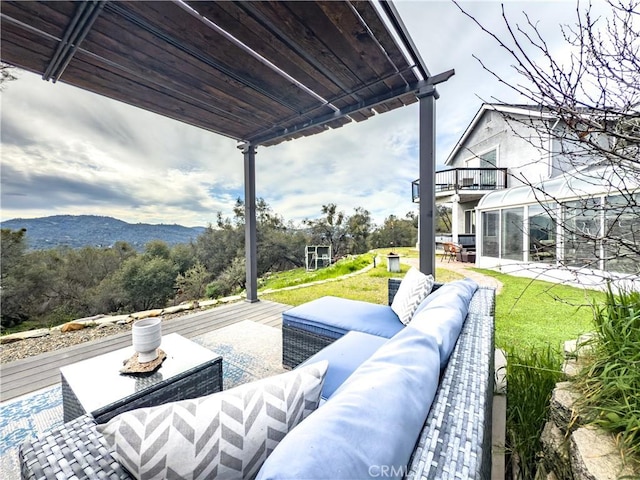 view of patio / terrace featuring a balcony, a mountain view, and an outdoor living space