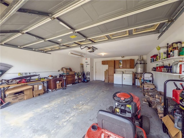 garage with a garage door opener, strapped water heater, and washing machine and clothes dryer