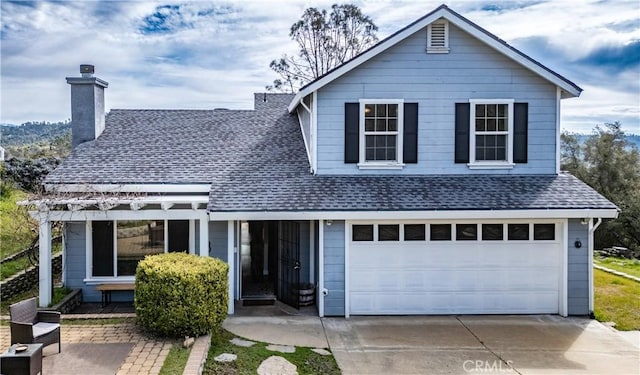 traditional-style home with a garage, driveway, roof with shingles, and a chimney