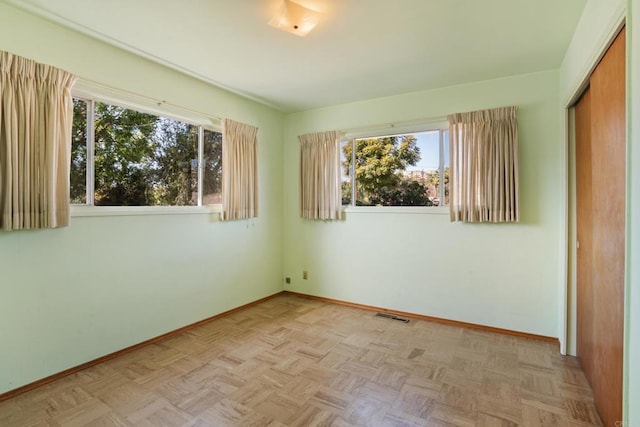 spare room with visible vents and baseboards