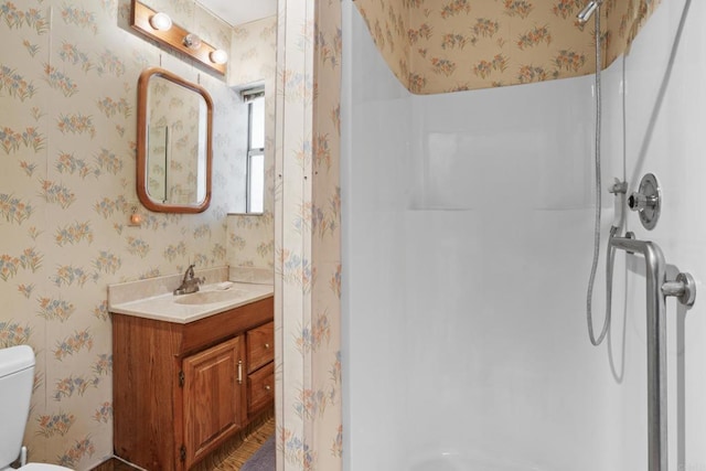 bathroom featuring walk in shower, toilet, and wallpapered walls