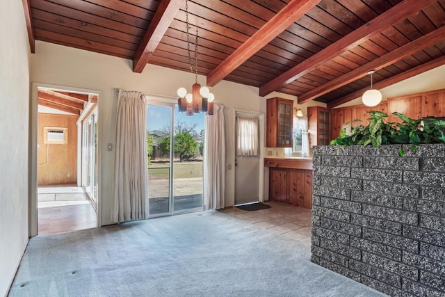 interior space with a wall unit AC, vaulted ceiling with beams, glass insert cabinets, wood ceiling, and light carpet